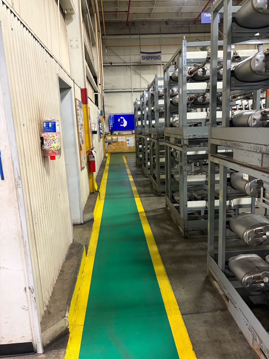 Swept warehouse shipping aisle with green safety lane at a West Tennessee industrial facility